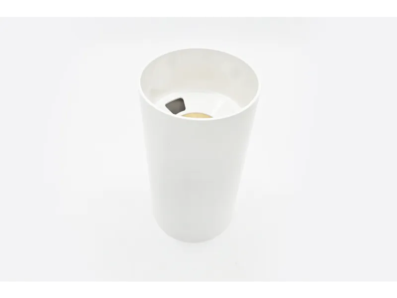 a white cylindrical object with holes in it