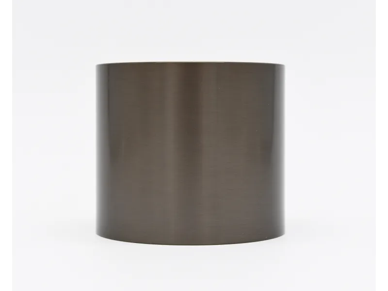 Smooth brushed dark metal cylinder with matte finish on a white background.
