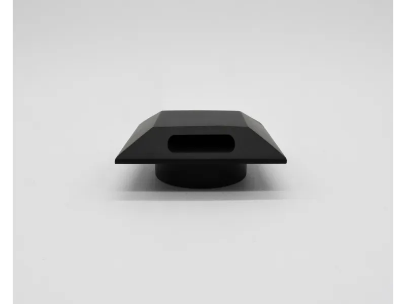 Matte black geometric object with a rectangular hollow center on a white background