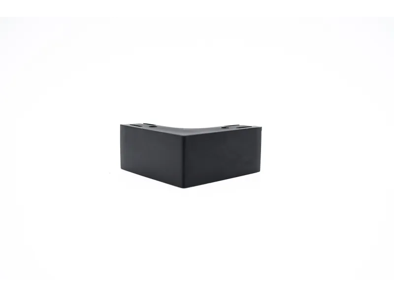 Black L-shaped plastic or rubber corner protector on white background for furniture or equipment.