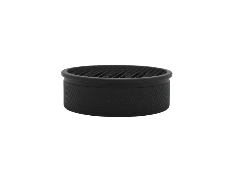 Black circular textured hockey puck with diamond pattern on a white background