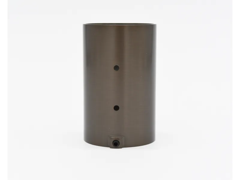 Brushed metal cylindrical object with two holes and a small connector at the base on white background