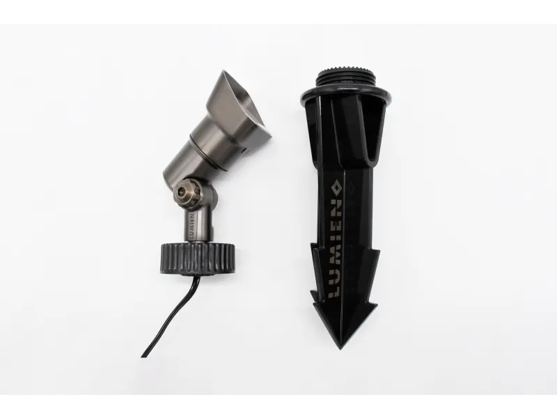 Metal garden spotlight with adjustable head and black plastic ground stake for outdoor lighting installation.