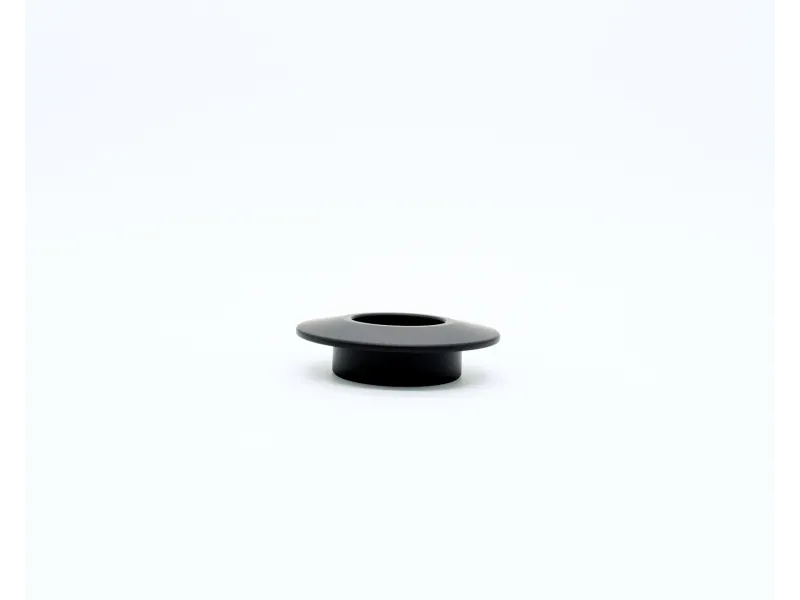 Small black plastic grommet or cable organizer with wide flange on white background.