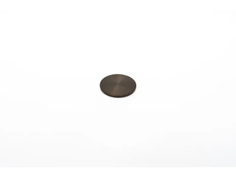 Small round black metal disc with a smooth surface isolated on white background