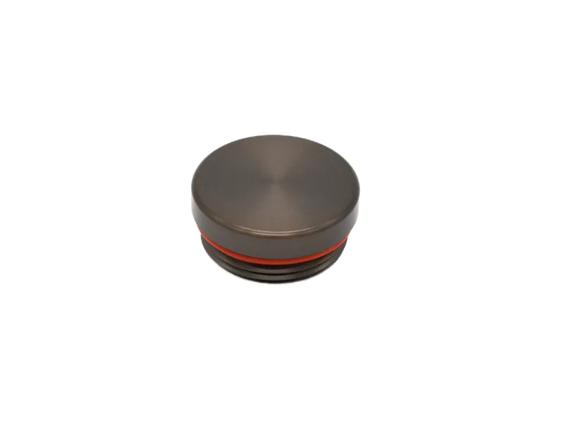 Dark brown circular metal cap with red gasket ring, isolated on white background.