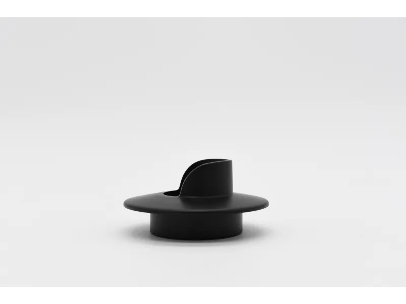 Black round plastic knob with a vertical grip on a white background, minimalist design.