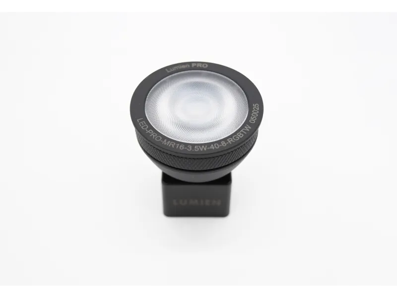 Compact Lumien PRO LED spotlight with black casing on white background, featuring text around lens edge.