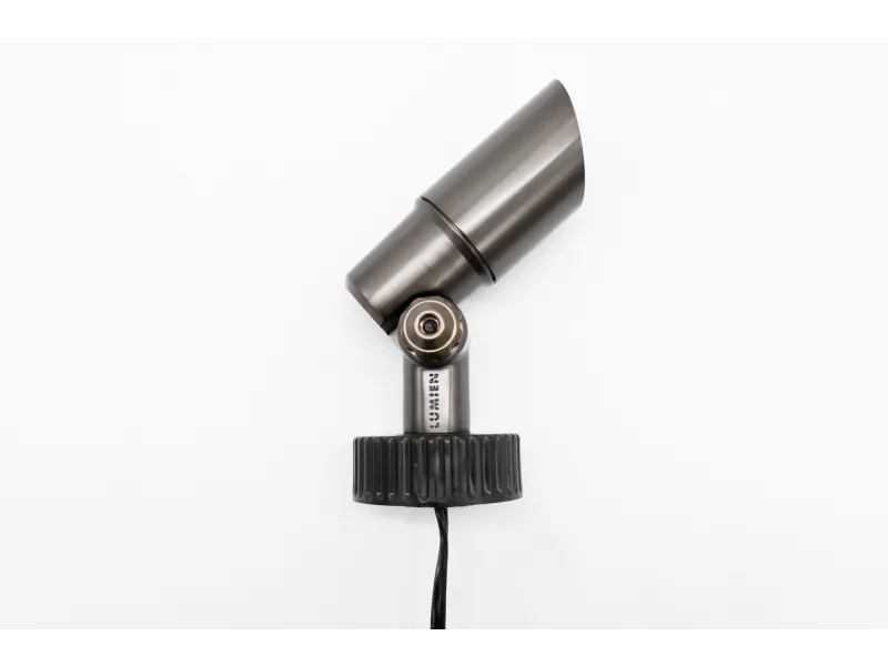 Adjustable metal spotlight with black mount and cable against a white background