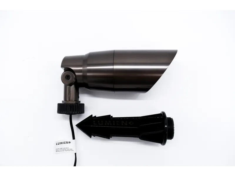 Dark metallic outdoor spotlight with black ground stake for garden or landscape lighting on white background