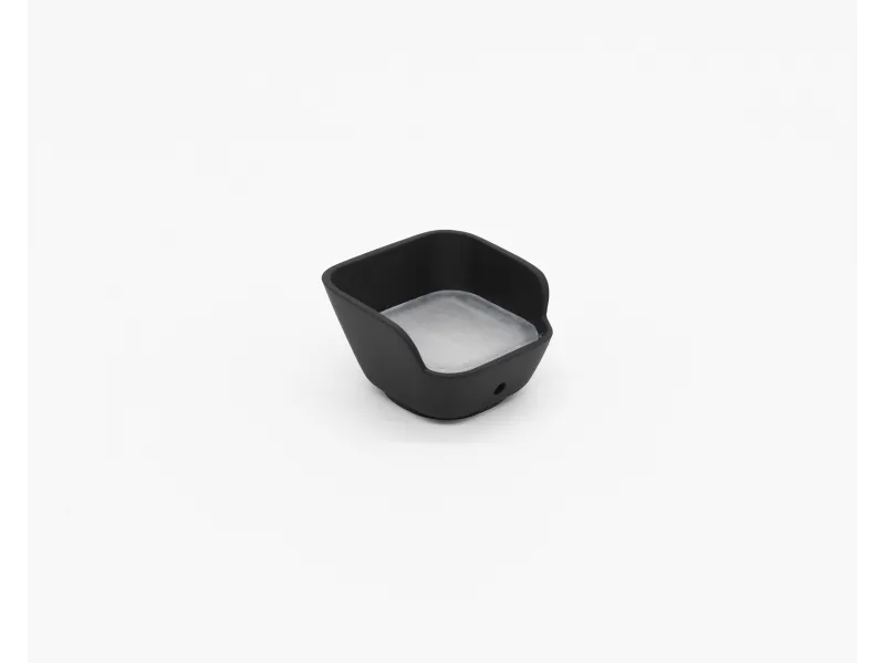 Small black silicone container with square shape and silver inner base on white background.