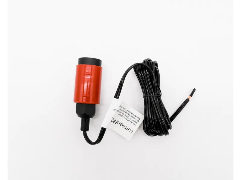 Red and black electronic sensor with attached coiled black cable on white background