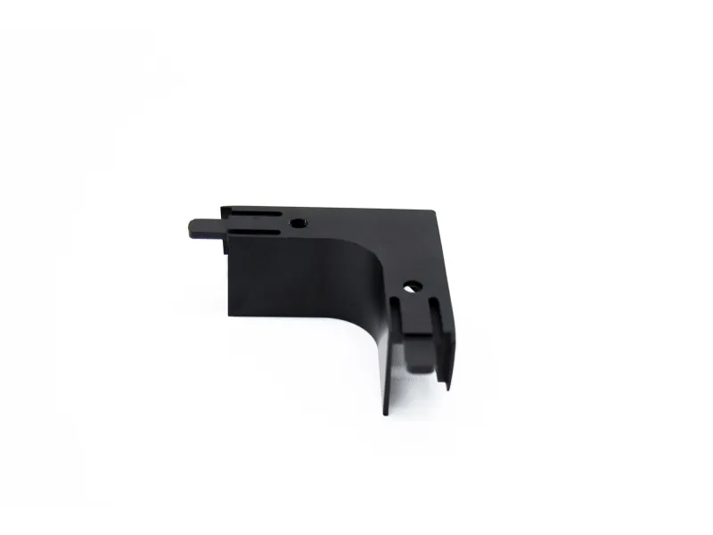 Black plastic right-angle bracket with multiple slots and holes against white background