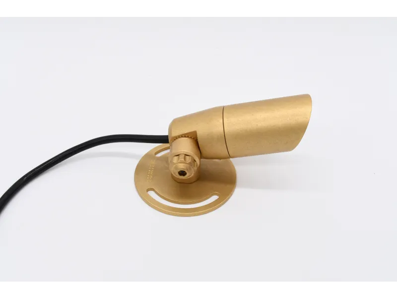 Gold-colored adjustable spotlight with black cord on white background, ideal for focused lighting.