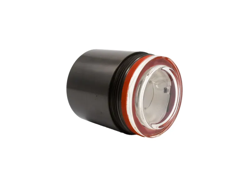 Black cylindrical flashlight lens with a transparent glass cover and orange ring on white background