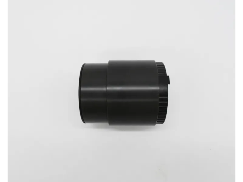 Black cylindrical camera lens extension tube on a white background