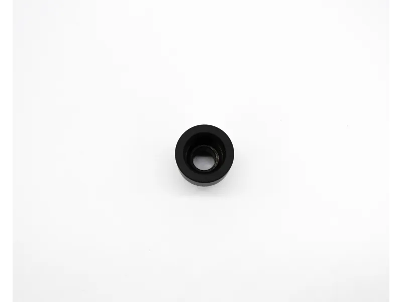Small black cylindrical rubber grommet with a central hole on a white background.