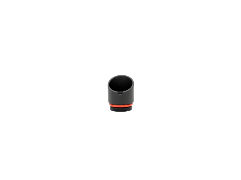 Black cylindrical plastic cap with red rubber gasket ring on white background