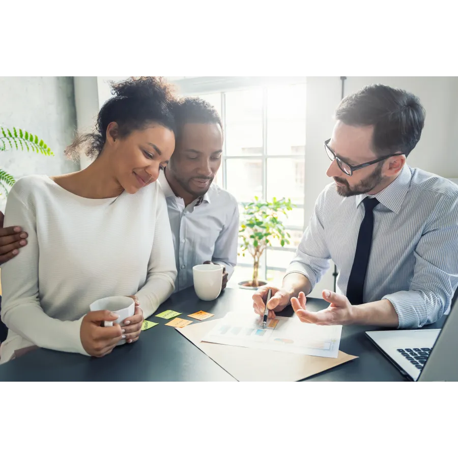 a group of people looking at a paper