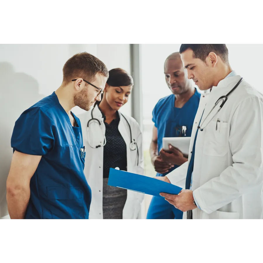 a group of doctors looking at a tablet