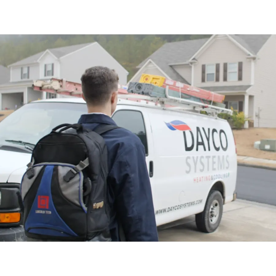 a man with a backpack looking at a white van