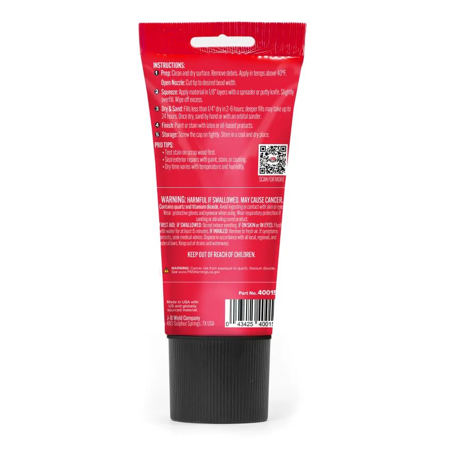 Back of red tube with black cap showing instructions, warnings, barcode, and QR code on white background.