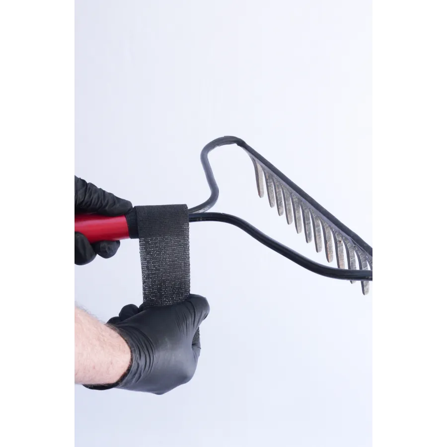 a hand holding a black and red barbell