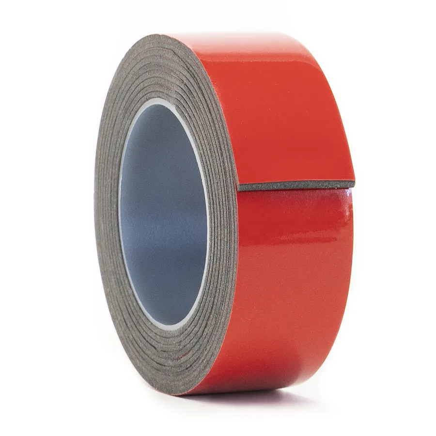 Roll of red double-sided adhesive foam tape with gray foam core on white background