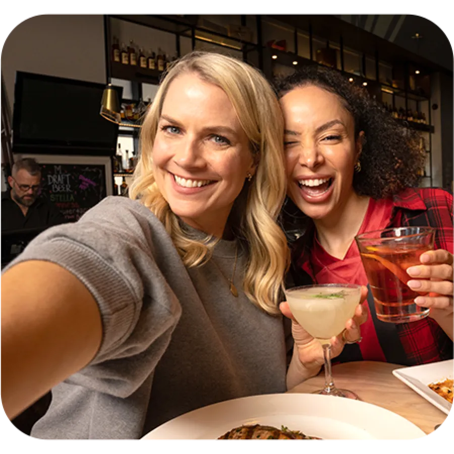 women holding drinks and smiling