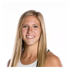 Young woman with long blonde hair smiling against white background, wearing a sleeveless top.