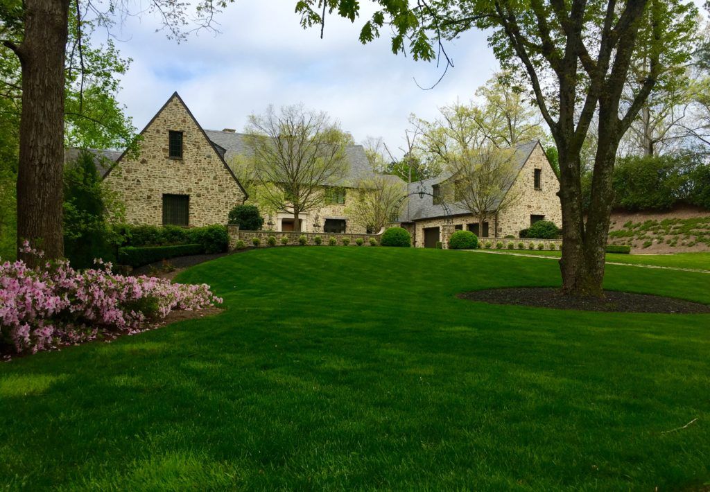 a green field in front of a house