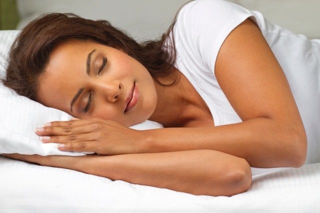 woman sleeping in bed with her head on a pillow