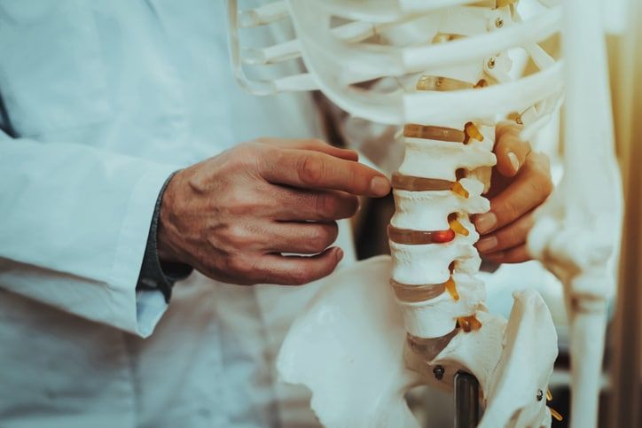 Man pointing at spine