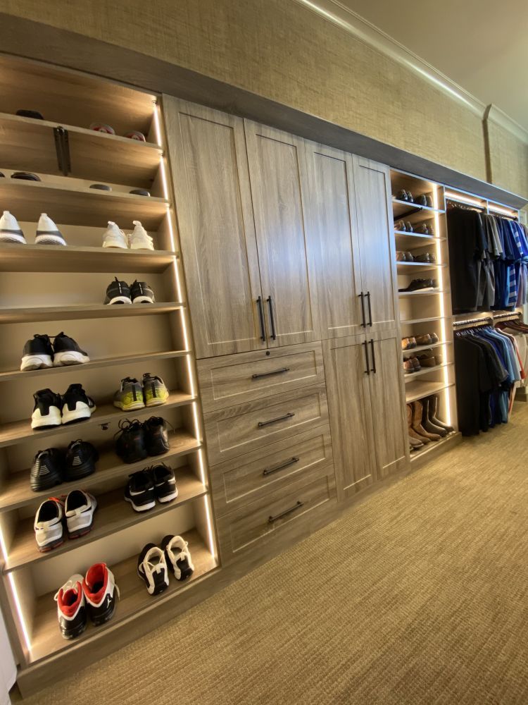 Close-up of the shoe organization cabinets in a men's luxury walk-in closet system 