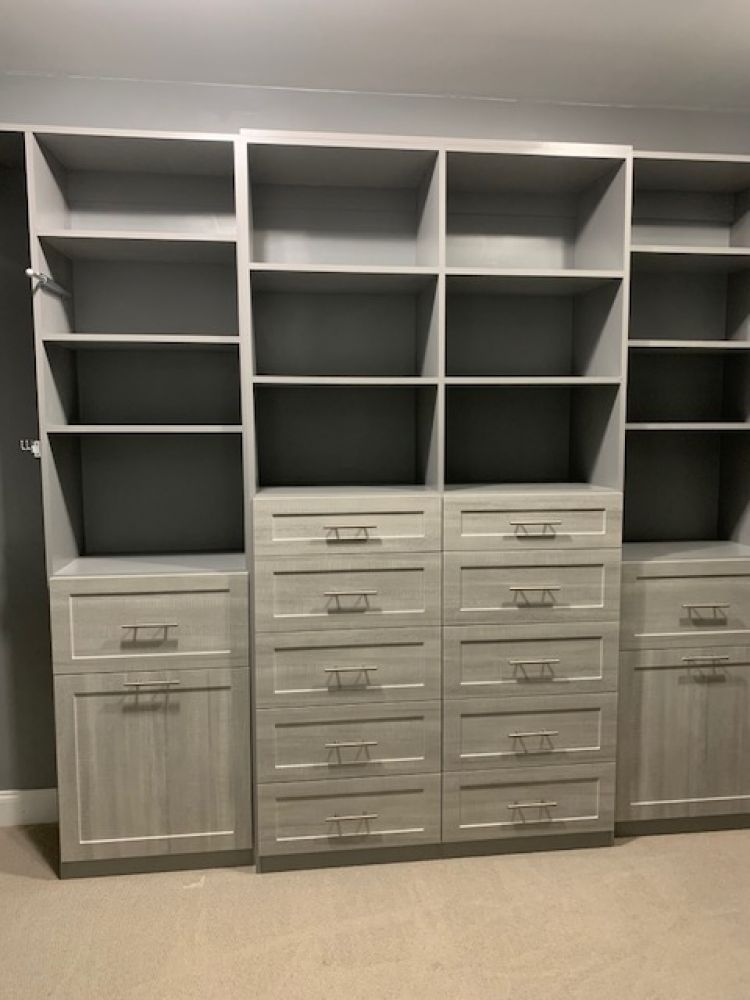 A master closet system featuring plentiful drawers and storage space.