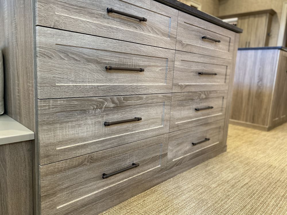 Close-up view of grey wash cabinets with dark hardware accents