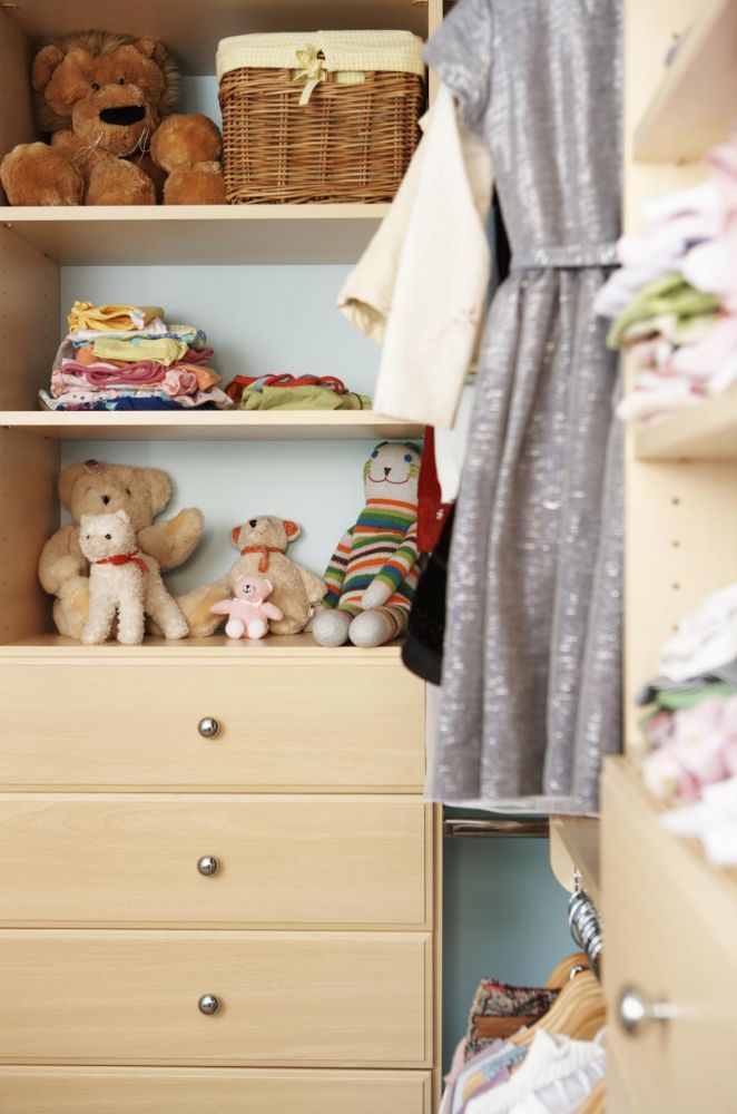 Closet storage system with stuffed animals and kids clothes