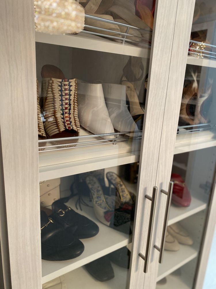 A close-up view of the shoe organization component of a luxury walk-in closet system