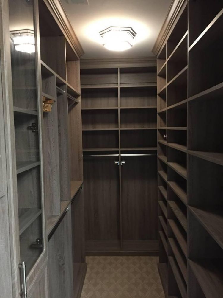 A large, empty walk-in closet with a deep brown color.