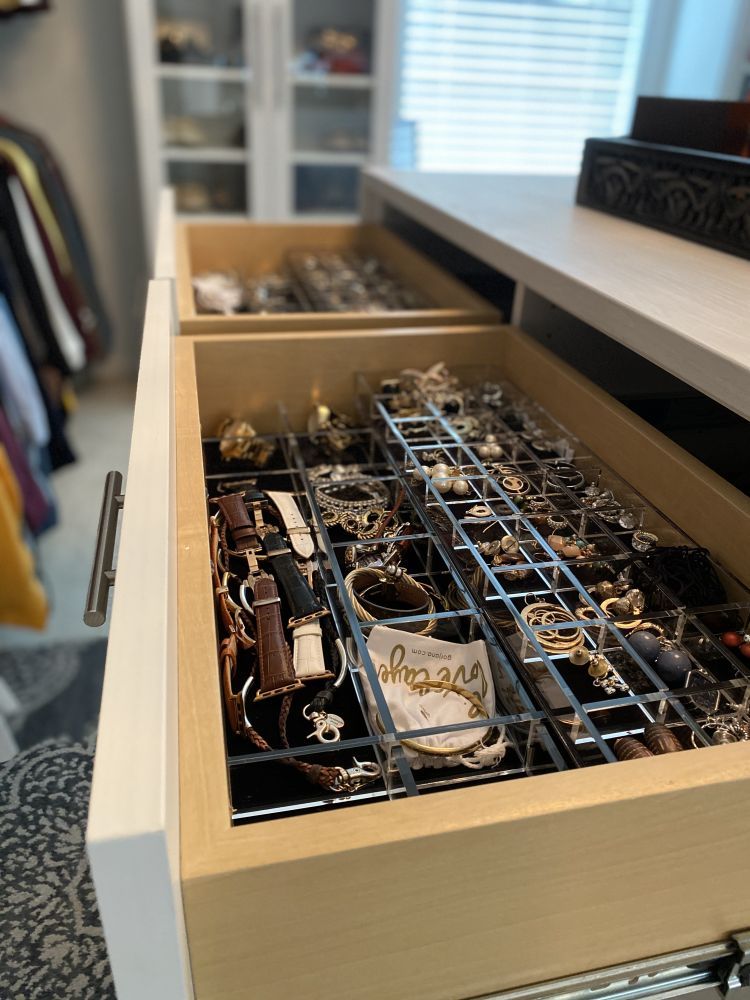 A close-up view of the jewelry organizer insert in a luxury walk-in closet system