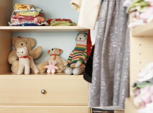 A kids closet system with stuffed animals.