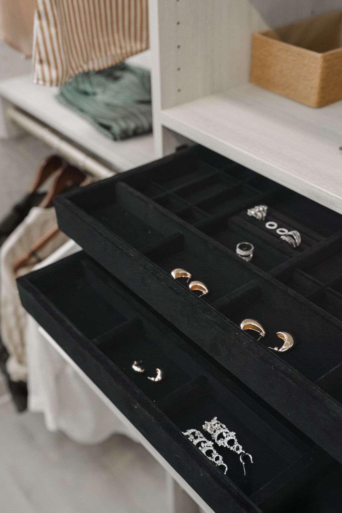 Pull-out felt-lined jewelry drawers in master bedroom custom closet 