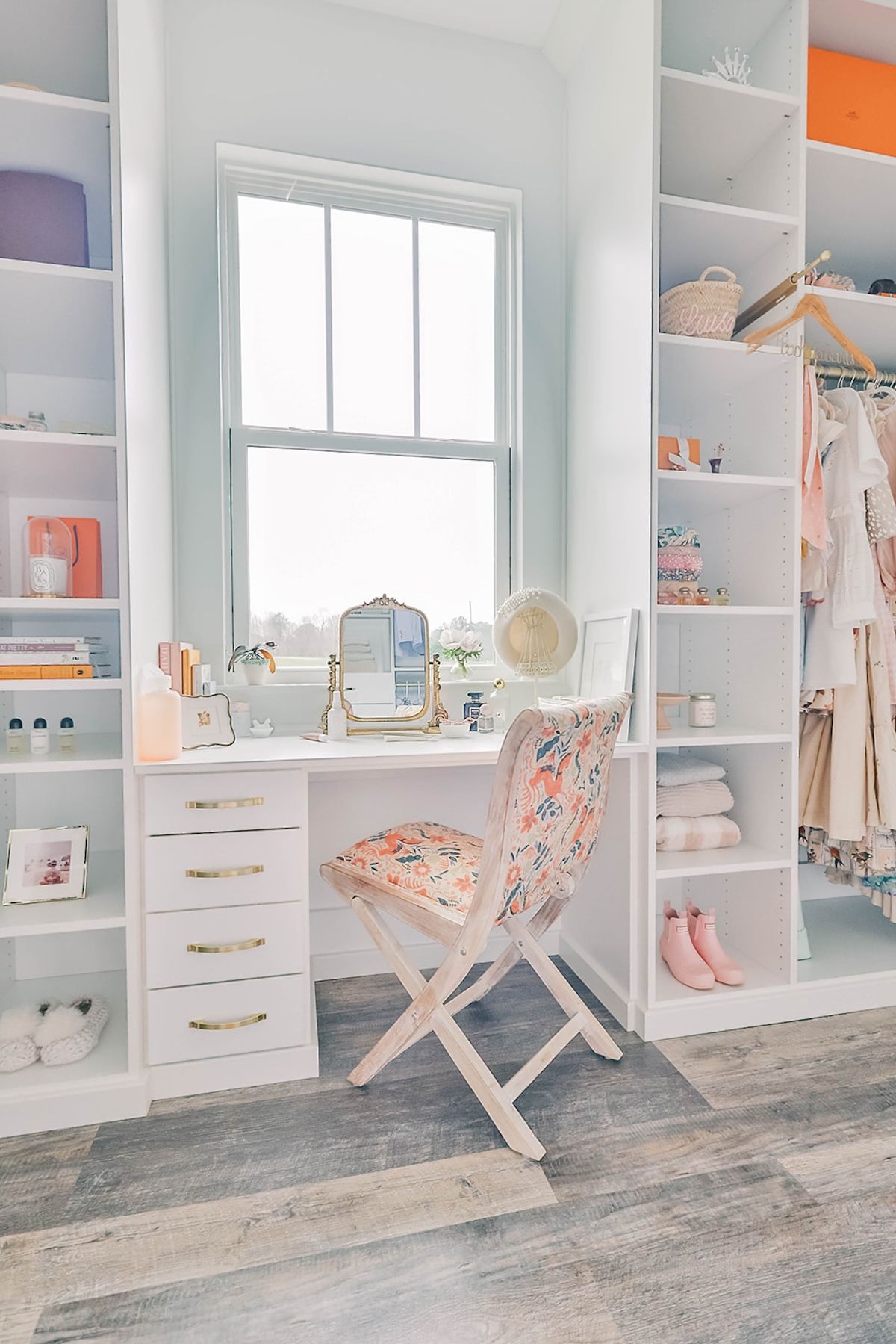 Custom vanity in white custom closet with bright light and window 