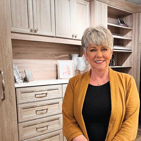 a picture of a woman standing in front of drawers