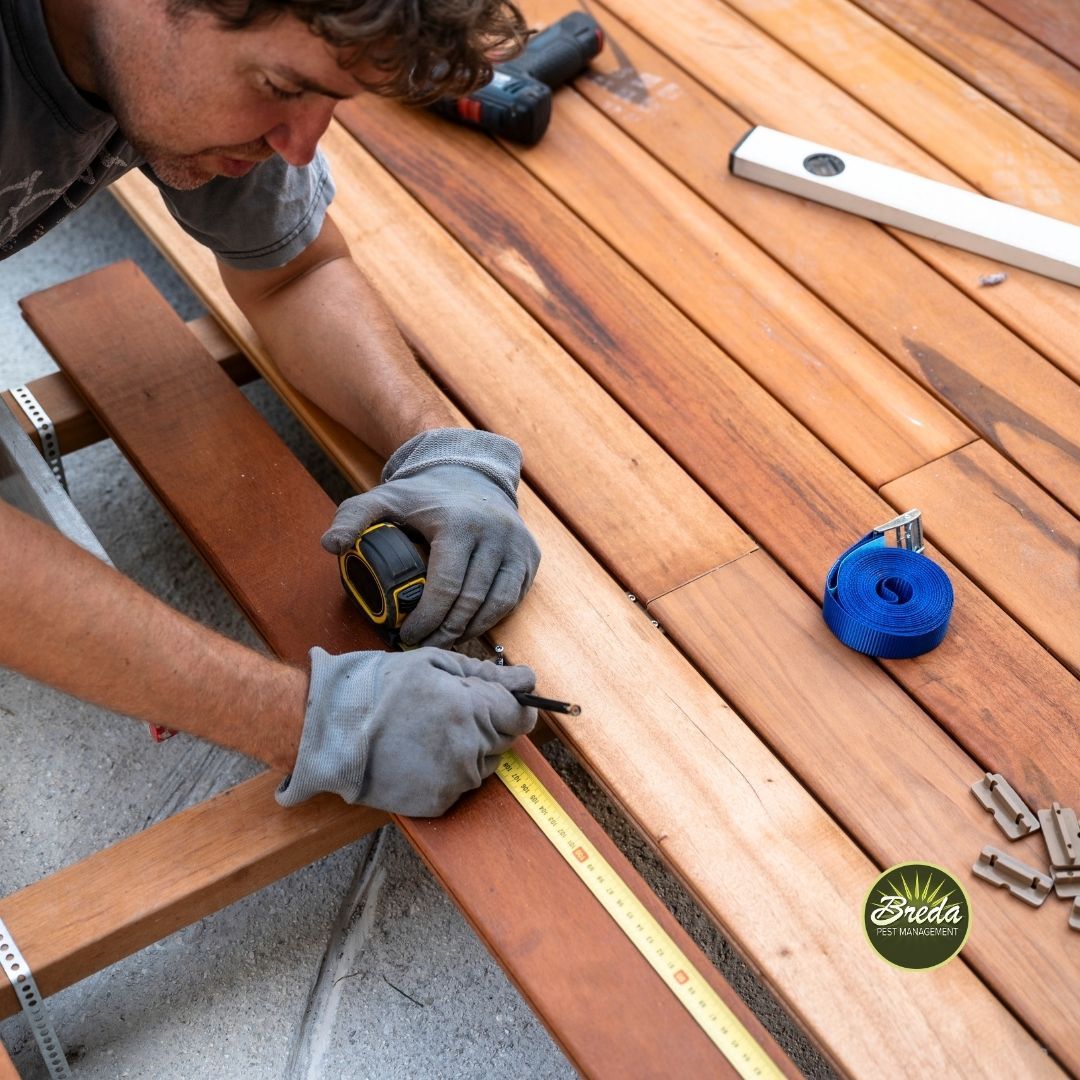man installing a wooden deck in a backyard carpenter bee control in Atlanta GA