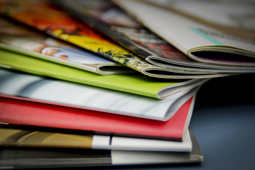 An assortment of Saddle-Stitched books lying on a table 