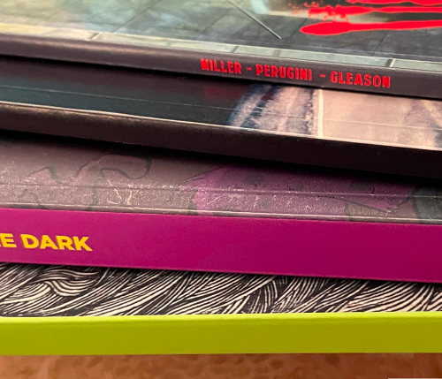 A stack of Perfect Bound Comic Books