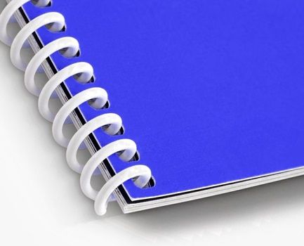 A spiral bound book with a blue cover and a white coil spine
