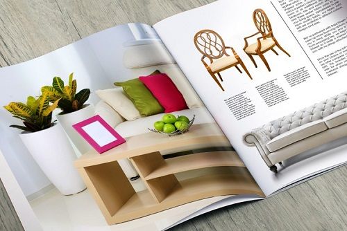 A colorful furniture catalog lying open on a table