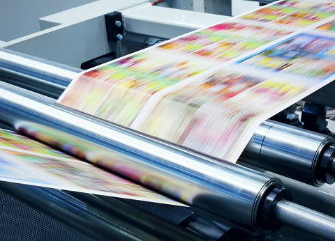 <em>Rolls of paper used for a Web press</em>Printed paper traveling through the rollers of a Web press